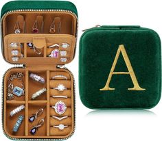 an open green case filled with lots of jewelry