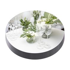 a table topped with lots of wine glasses and flowers