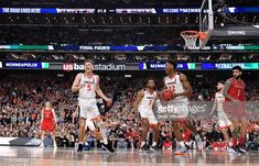 the u s men's basketball team is walking off the court