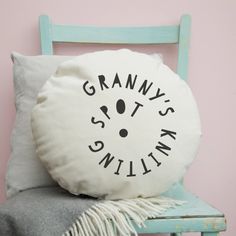 a white pillow sitting on top of a blue chair