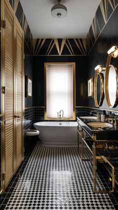 a black and white tiled bathroom with gold trim around the tub, double sinks, and two mirrors