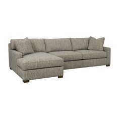 a large gray couch sitting on top of a white floor