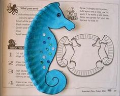 a blue sea horse sitting on top of a piece of paper