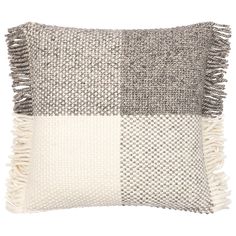 a gray and white pillow with fringes on the front, two different color squares