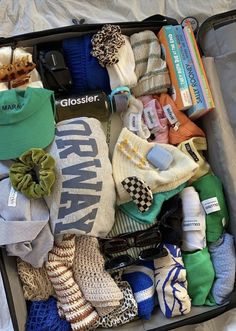 an open suitcase filled with clothing and accessories