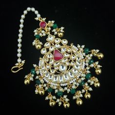 Kundan jewelry is 100% Handmade Indian Jewelry, best to wear it for traditional ceremonies or Indian weddings. This bridal jewelry has an ethnic finish. It has Polki Kundan stones with pearls in pink and green combinations. There are long and short patterns in Kundan jewelry. Maang tikkas give a glamorous outlook to traditional outfits. It has a Bollywood style to suit every occasion and goes really well with South and North Indian weddings.   Measurements: 7-8 inches long Color, shades, texture displayed may slightly vary from the actual product due to digital image limitations. We request you to consider these minor variations. Please expect the possibility of some slight imperfections when buying handmade jewelry. If you have any questions, please contact us. CARE: Keep jewelry away fro Festive Kundan Tikka For Rituals, Kundan Jewelry For Eid Rituals, Bollywood Jewelry For Eid Rituals, Bollywood Style Jewelry For Eid Rituals, Bollywood Style Hand Set Tikka For Eid, Traditional Hand Set Tikka For Eid, Traditional Jewelry For Eid Rituals, Traditional Kundan Hand-set Tikka, Hand Set Kundan Tikka For Festivals