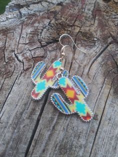 These cute cactus earrings feature a colorful western look. Cute Multicolor Jewelry With Ear Wire, Cute Multicolor Jewelry, Multicolor Southwestern Summer Jewelry, Casual Multicolor Dangle Jewelry, Cute Multicolor Drop Earrings, Casual Multicolor Nickel-free Jewelry, Casual Multicolor Earrings For Festivals, Casual Multicolor Festival Earrings, Southwestern Multicolor Drop Earrings