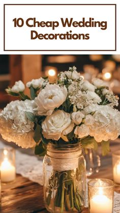 Affordable wedding decorations with white floral arrangements in mason jars wrapped in lace, complemented by glowing candles on a rustic wooden table.