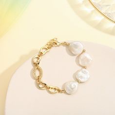 This exquisite Pearl Hollow Chain Bracelet will accessorize any outfit with timeless elegance. Crafted from 18k gold and delicate pearl chains, this bracelet exudes sophistication and style, making it the perfect addition to any luxury ensemble. DETAILS Plating: 18k Gold on Brass Materials:   18K Gold on Brass, Freshwater Pearl Measurements: Length: 6.30"(16.0cm) + Extender: 1.97"(5.0cm) Weight:  13.27g Note: It will be in stock in 7 business days! Elegant Bracelet With Baroque Pearl Charm, Elegant Pearl Chain Bracelet With Pearl Drop, Elegant Metal Chain Bracelet With Pearl, Elegant Gold Bracelet With Baroque Pearl, Elegant White Chain Bracelet With Pearl Charm, Elegant White Chain Bracelet With Pearl Drop, Elegant White Pearl Bracelet With Adjustable Chain, Elegant Baroque Pearl Bracelet, Elegant Metal Bracelets With Pearl Chain