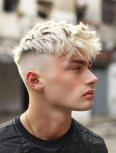 a young man with blonde hair wearing a black shirt