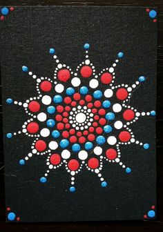 a painting with red, white and blue dots in the center on a black background