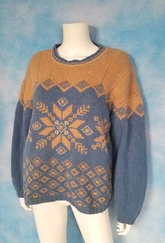 "Epically thick and cozy Shetland wool pullover sweater in a surprisingly attractive and eye-catching color combination of slate blue and camel. Fair isle/Nordic style patterns of snowflake-like designs and diamonds. A little scratchy but mostly pretty soft. So warm you can wear it as an outer layer! A little pilling but otherwise good condition. Decade: 1990s Label: Maurices Material: shetland wool Closure: pull over Vintage Condition: Very Good (From a pet and smoke free home) Measurements are taken flat and doubled where necessary. This is marked size large. Neck: 20\" Shoulder span: 25\" Sleeve length: 19\" Upper arm: 18\" Cuff: 9\" Bust: 47\" Length: 24.5\" NO RETURNS - ALL SALES ARE FINAL. Please check the measurements I've given, and measure yourself or a garment that fits you well Nordic Blue Crew Neck Sweater, Blue Nordic Crew Neck Sweater, Blue Nordic Knit Sweater, Blue Fair Isle Sweater For Cold Weather, Blue Wool Sweater With Fair Isle Pattern, Nordic Knitted Blue Sweater, Blue Nordic Sweater With Fair Isle Pattern, Cozy Blue Sweater With Fair Isle Pattern, Blue Fair Isle Pattern Winter Sweater