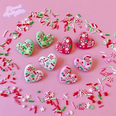 there are many heart shaped candies in the shape of hearts and candy canes