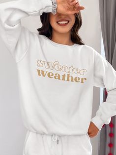 Bundle up, buttercup! Our "Sweater Weather" Sweatshirt is here to wrap you in a cozy embrace warmer than your ex's apology text. This isn't just a sweatshirt – it's a wearable ode to that magical time of year when leaves turn crisp and your dating standards turn flexible. Perfect for sipping pumpkin spice lattes, pretending to enjoy football, or aggressively cuddling your cat while scrolling through dating apps. With this sweatshirt, you're not just embracing autumn, you're practically french-ki Winter Sweats Relaxed Fit Super Soft, Winter Sweats With Relaxed Fit And Super Soft Texture, Winter Sweats With Relaxed Fit And Super Soft, Super Soft Relaxed Fit Winter Sweats, Winter Relaxed Fit Super Soft Sweats, White Winter Leisure Sweater, White Winter Sweatshirt For Leisure, White Sweatshirt For Leisure, Winter Season, White Sweatshirt For Leisure In Winter