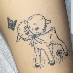 a small teddy bear tattoo on the thigh