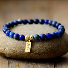 The Handmade Natural Lapis Lazuli Beaded Bracelet with a Gold Plated Tag looks great. It will make the perfect gift 🎁 for someone special, or treat yourself as you deserve it 💖 🥰 These Bracelets have been made using high quality Natural Lapis Lazuli and have a Gold Plated Tag with MC for MantraChakra. They are available as 4mm, 6mm and 8mm. Lapis Lazuli brings out your inner priestess, heightens inner-vison and deepens wisdom. It benefits the Throat Chakra with communication and expression of Minimalist Beaded Bracelets As Gift, Gift Lapis Lazuli Round Bead Bracelets, Gift Lapis Lazuli Bracelets With Round Beads, Lapis Lazuli Bead Bracelet Gift, Gift Lapis Lazuli Beaded Bracelets With Polished Beads, Lapis Lazuli Beaded Bracelet Gift, Lapis Lazuli Gemstone Beads Bracelet For Gift, Lapis Lazuli Gemstone Beaded Bracelet For Gifts, Lapis Lazuli Beaded Bracelets As Gift