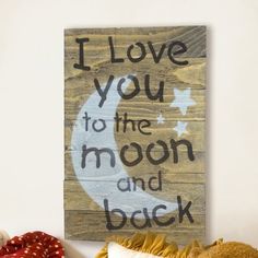 a wooden sign that says i love you to the moon and back with a teddy bear