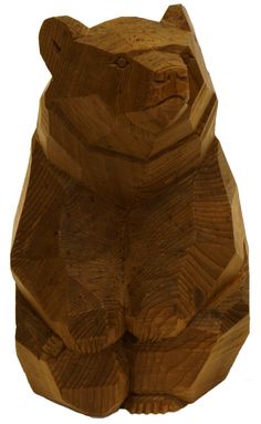 a carved wooden bear sitting on its hind legs