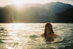 a woman in the water with her mouth open