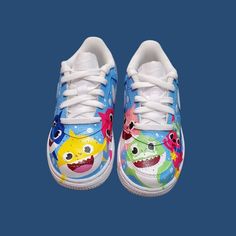 Custom hand painted air force 1 shoes. Baby shark character theme . Prices vary depending size. Cost of shoes included in the price. Fun Low-top Sneakers With Cartoon Print, Blue Sneakers With Custom Artwork, Hand Painted Round Toe Sneakers For Fun, Hand Painted Air Force 1, Shark Character, Painted Air Force 1, Air Force 1 Shoes, Sneakers Athletic, Theme Birthday