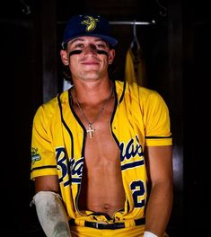 a man in a baseball uniform is posing for the camera