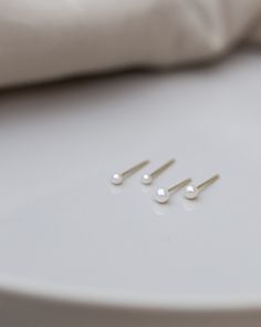 Mini Pearl Studs Perfect 14k gold smaller sized pearl studs for your everyday wear. Minimalist and elegant as a pair or as a single stud on your second or third ear piercing. 14k gold post and backings choose from 2 sizes: Smaller 1.75-2mm Small 2.75-3mm Tiny Minimalist Earrings For Wedding, Tiny Elegant Pearl Earrings For Gifts, Minimalist Pearl Charm Earrings For Anniversary, Minimalist Pearl Earrings As Gift, Minimalist 14k Gold Filled Pearl Earrings For Anniversary, 14k Gold Dainty Pearl Earrings For Anniversary, Dainty 14k Gold Pearl Earrings For Anniversary, Dainty White Gold Pearl Earrings For Everyday, Minimalist Yellow Gold Pearl Earrings For Everyday