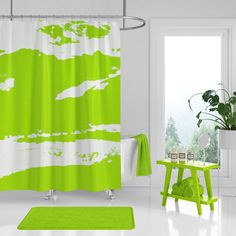 a green and white shower curtain in a room with a table, chair and potted plant