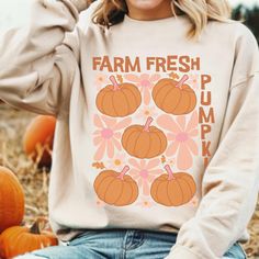 This super-soft fleece-lined Farm Fresh Pumpkins Sweatshirt features a cute abstract floral and pumpkin design and is perfect for Cozy Season! Printed on Gildan unisex sweatshirts for the ultimate in cozy comfort. Please check the size charts for the perfect fit! Details: ✔ 50% ethically grown cotton, 50% polyester ✔ Medium-heavy weight fabric for the perfect amount of warmth ✔ Premium DTG prints - no peeling or cracking ✔ Classic fit in your regular size ✔ Easy care: Machine washable, maintains Cute Graphic Print Sweater For Fall, Cute Relaxed Fit Sweatshirt For Fall, Graphic Print Cozy Fit Sweatshirt For Fall, Cozy Fit Graphic Print Sweatshirt For Fall, Cozy Fit Graphic Sweatshirt For Fall, Trendy Orange Sweatshirt For Fall, Thanksgiving Sweater, Pumpkin Sweatshirts, Change Of Address