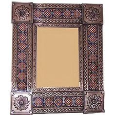 an ornate mirror with decorative designs on the front and sides, is shown against a white background