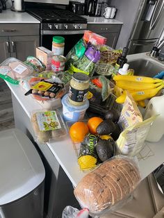 a kitchen counter covered in food and condiments