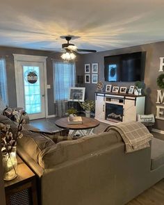 a living room filled with furniture and a flat screen tv mounted to the wall above it