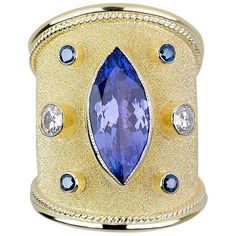 One of a kind S.Georgios design Hand Made 18 Karat Yellow Gold Ring decorated with Byzantine-style granulation and unique velvet look on the background. The ring features a 3.59 Carat Center Marquise Natural Tanzanite, two Brilliant Cut White Diamonds total weight of 0.40 Carat and 4 Brilliant cut Blue Diamonds total weight of 0.22 Carat. The ring is outstanding in quality of workmanship and stone collection and is made in our workshop in Athens Greece. Size: 8 (can be custom made to fit any siz Byzantine Ring, Byzantine Rings, Statement Rings Diamond, Tanzanite Diamond Ring, Tanzanite Diamond, Purple Jewelry, Gold And Silver Rings, Yellow Gold Ring, Blue Diamond