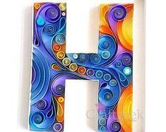 the letter h is painted with colorful swirls on it's sides and sits in front of a white wall