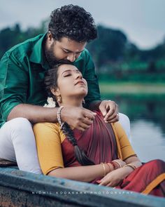 a man and woman sitting on top of a boat next to each other in the water