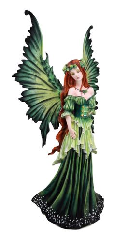 a green fairy figurine with wings