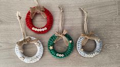 three christmas wreath ornaments hanging from twine