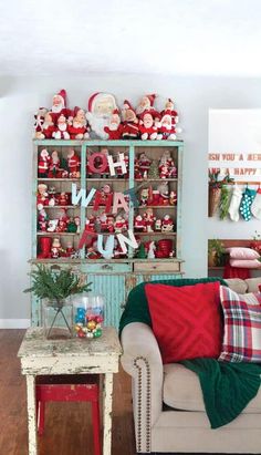 a living room filled with furniture and christmas decorations on top of it's shelves