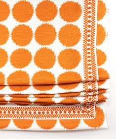 an orange and white polka dot print sheet set with matching pillow cases on top of each other