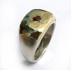 A pinky ring made of sterling silver and 10k yellow gold sheet soldered on top, hammered and set with Garnet. This ring can fit other fingers as well. You can choose the gemstone from this list: red garnet / cz / turquoise / blue topaz / sapphire / peridot / pearl / amethyst. Measurments: Width: 0.43 inch x 0.59 inch / 11 mm x 15 mm Thickness:0.11 inch / 3 mm This listing is for sizes 3.5-8 For other sizes - please convo me. Additional information If you liked this item, you may also want to loo Silver Jews, Lost Wax Jewelry, Rectangular Ring, Pearl Amethyst, Big Stone Ring, Medieval Jewelry, Dope Jewelry, Garnet Jewelry, January Birthstone