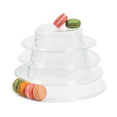 a stack of plastic plates with macaroons on top