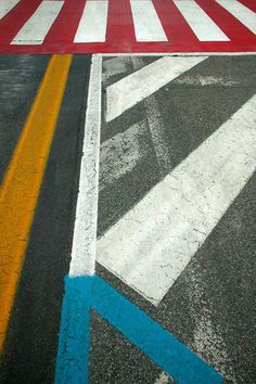 an empty parking lot with red, white and blue painted lines