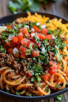 a plate of spaghetti with meat and vegetables