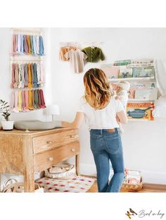 a woman standing in front of a dresser