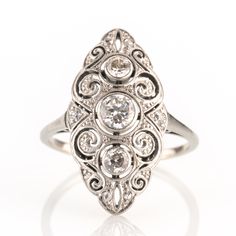 An early 1920s ring beautifully showing the typical Art Deco jewelry elements in an early version! Delicate craftmenship in precious white metal, in this case platinum, teams up with symmetric design and a set of diamonds in various cuts.   Metal 0.950 platinum Gemstones 9 diamonds 0.50ct (H-I/SI-P) Measurements Head 23.0mm Shank 1.5mm Ring size 6.5 US Weight 3.2g Condition Excellent condition   General Information All items come with certificate of authenticity, gemstones have been tested at ou Antique Platinum Three Stone Diamond Ring, Antique Platinum Three-stone Jewelry, Art Deco Oval Platinum Diamond Ring, Antique Three Stone Platinum Rings, Antique Platinum Three Stone Rings, Heirloom Three Stone Platinum Ring, Heirloom Platinum Three Stone Ring, Heirloom Platinum Three-stone Ring, Heirloom Three-stone Platinum Ring