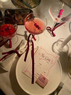 the table is set with two martinis and place settings for guests to enjoy their meal