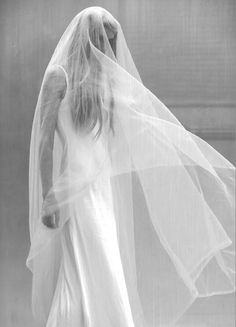 black and white photograph of a woman wearing a veil