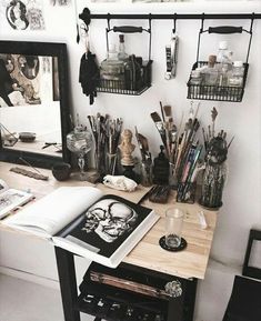 a desk with many items on it in front of a mirror