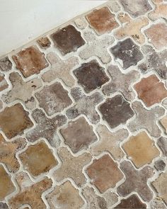 a cat laying on top of a tiled floor