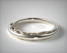 a white gold wedding ring on a gray background