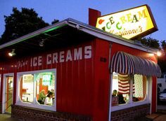 an ice cream shop at night with the lights on